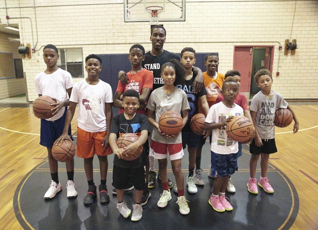 Tasheed Carr with young basketball players at a Born Leader Family camp